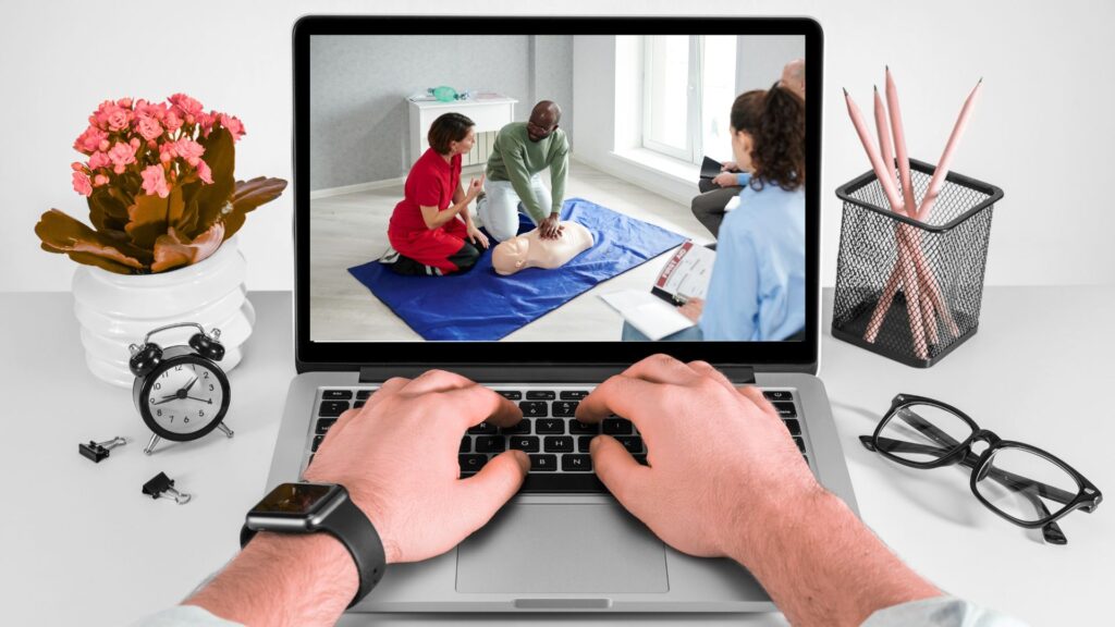 Man watching an instructor-led CPR training course on a laptop