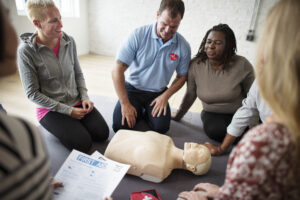 CPR instructor leading an Instructor Certification class with demonstration dummy