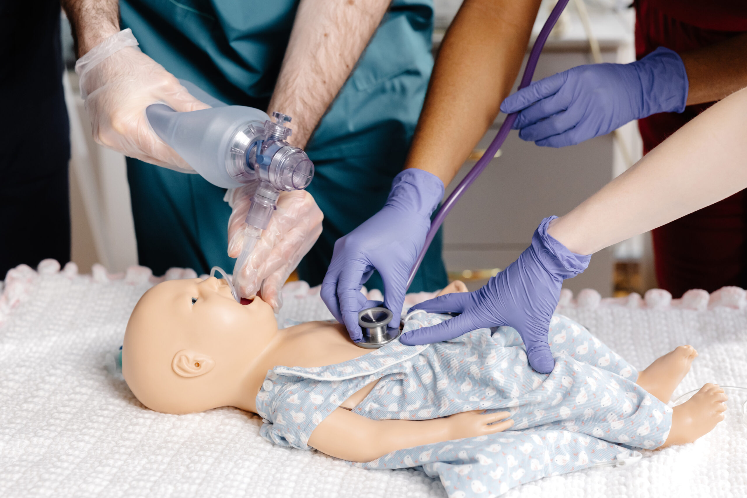 PALS instructor demonstrating pediatric assessment techniques during pediatric emergency response training class